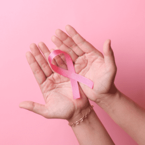 A Hand Holding a Pink Color Ribbon